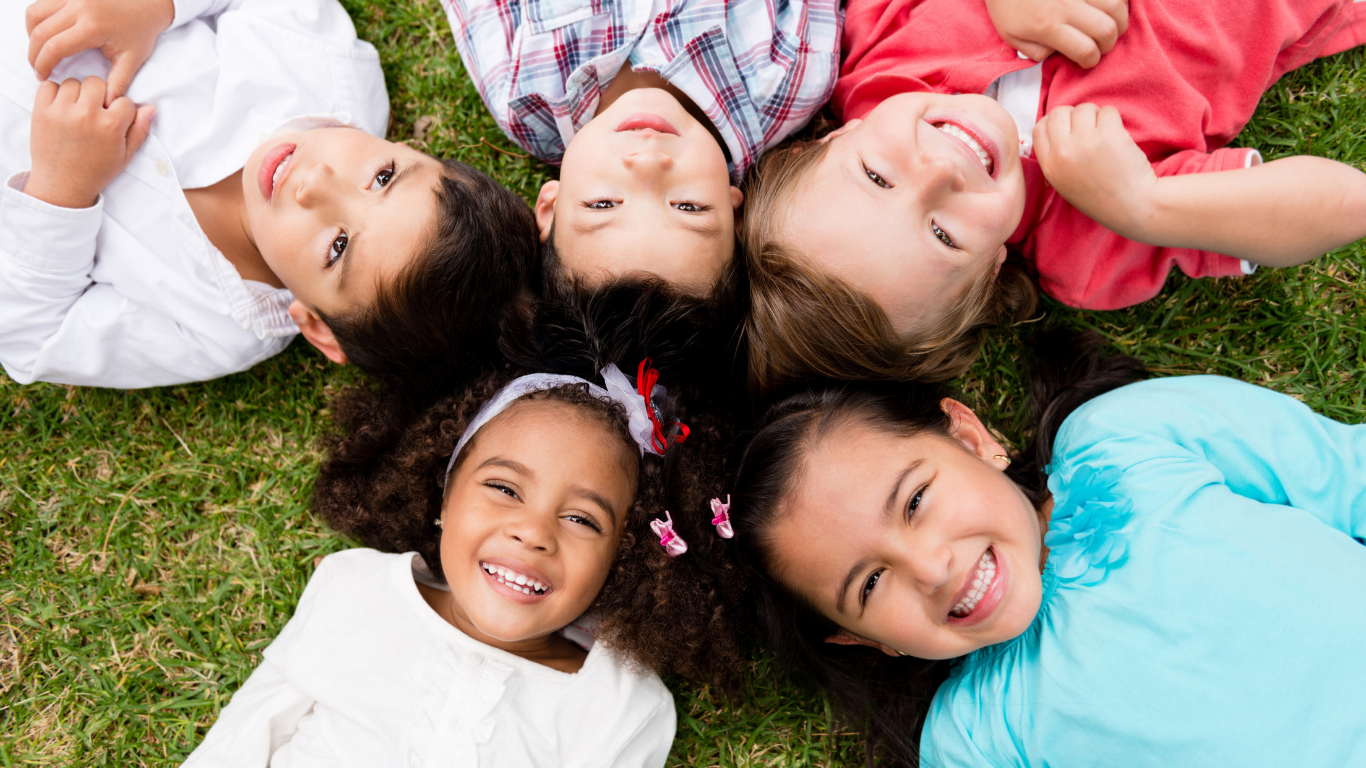 Children laying on grass